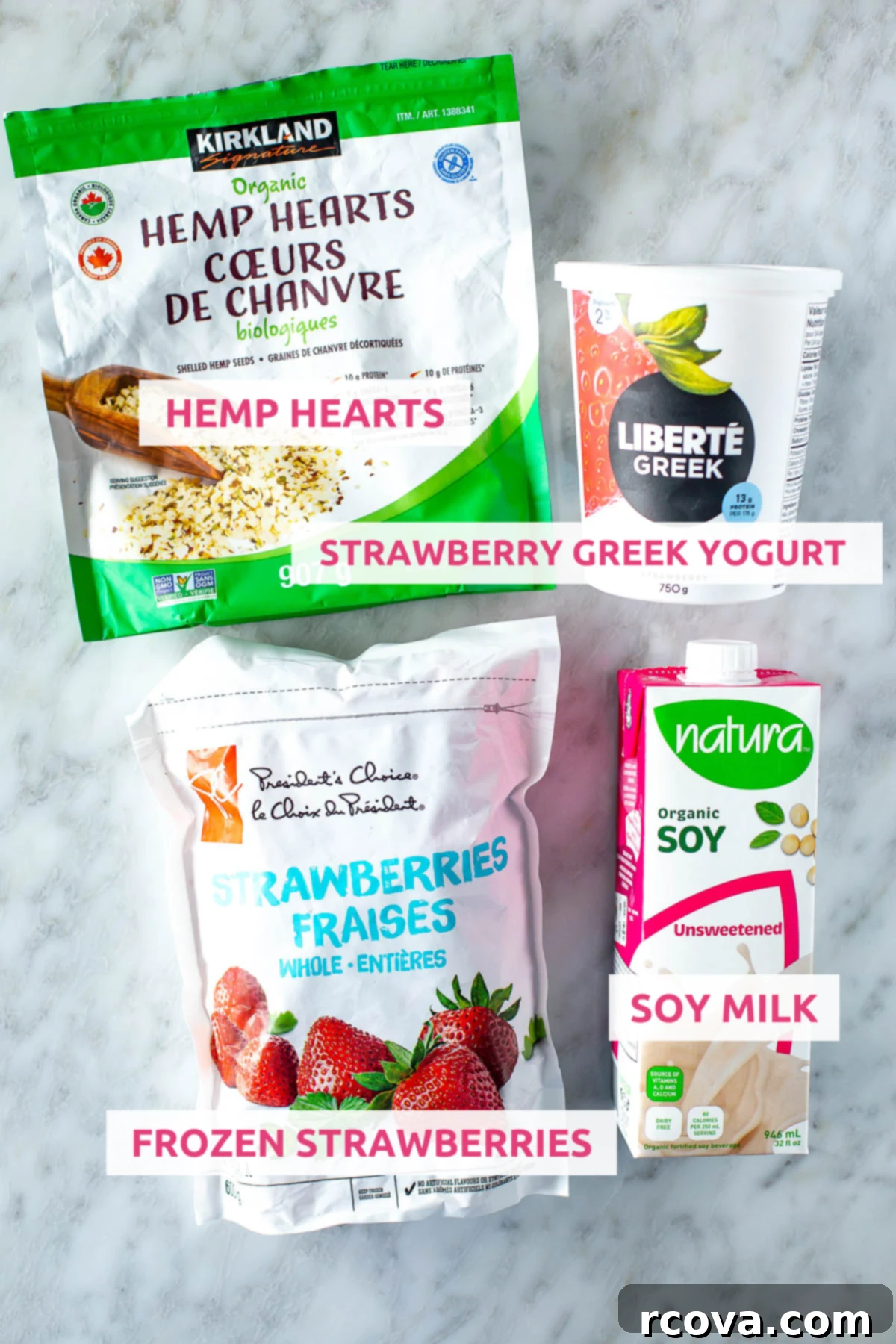 High-Protein Strawberry Power Smoothie 4 Overhead shot of all the high-protein strawberry smoothie ingredients laid out with labels, including frozen strawberries, Greek yogurt, soy milk, and hemp hearts.