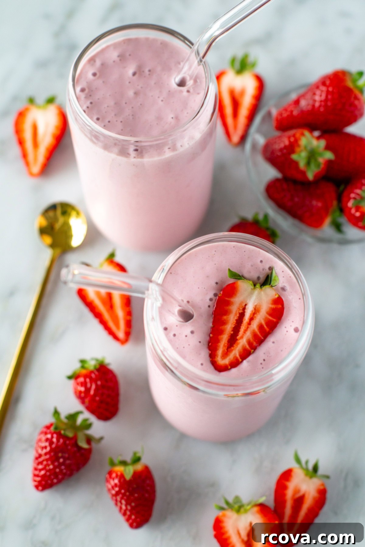 High-Protein Strawberry Power Smoothie 7 Overhead shot of two glasses of high-protein strawberry smoothie, garnished with fresh berries and ready to drink.