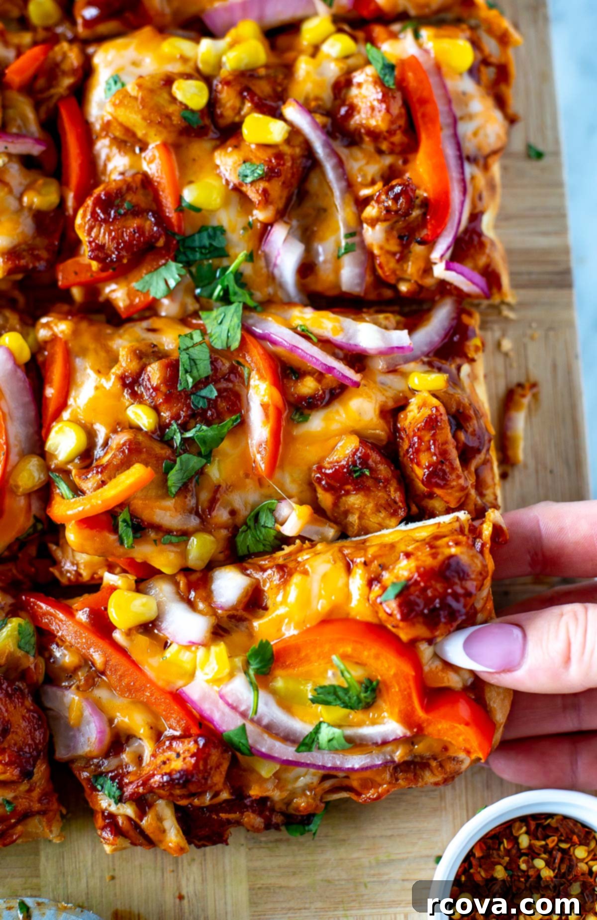 Effortless BBQ Chicken Flatbread 9 overhead shot of a single slice of BBQ Chicken Flatbread, showcasing the melted cheese and fresh toppings.