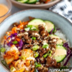 Weeknight Korean Beef Bowls 10 Side shot of a Korean Beef Bowl with another bowl blurred in the background.