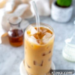 Instant Iced Vanilla Latte 10 Overhead shot of an iced vanilla latte in a clear glass with ice and a straw.