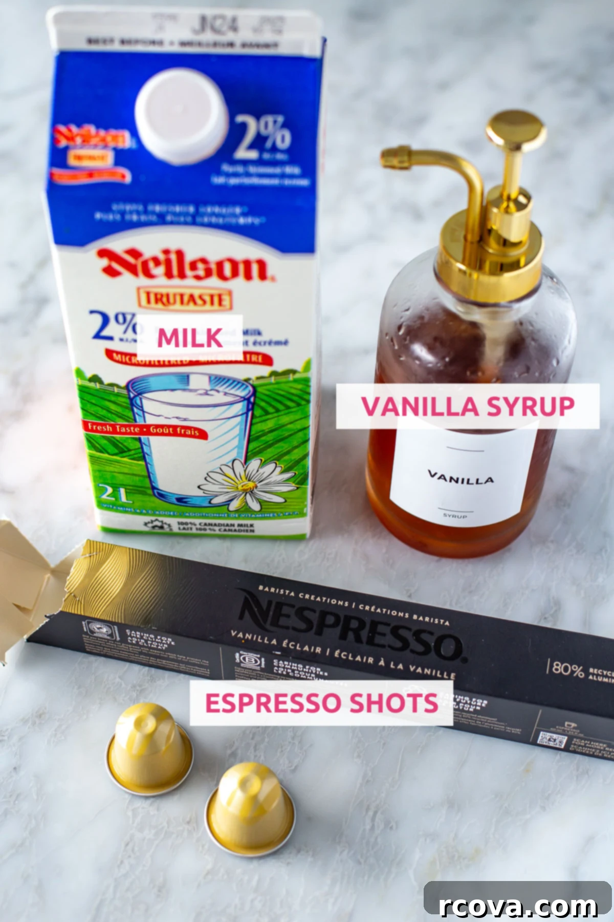 Instant Iced Vanilla Latte 4 Overhead shot of ingredients for Iced Vanilla Latte: milk, vanilla syrup, and espresso pods with labels.