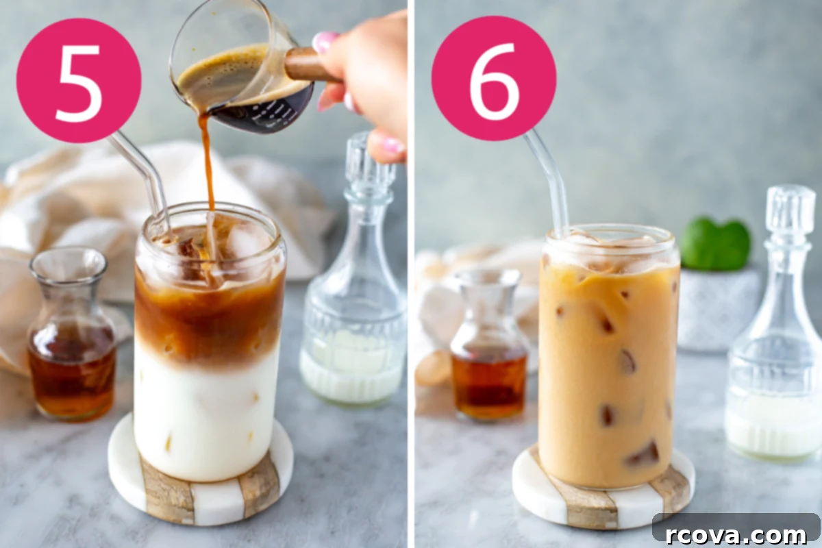 Instant Iced Vanilla Latte 7 A hand pouring freshly brewed espresso into a glass filled with milk and ice.