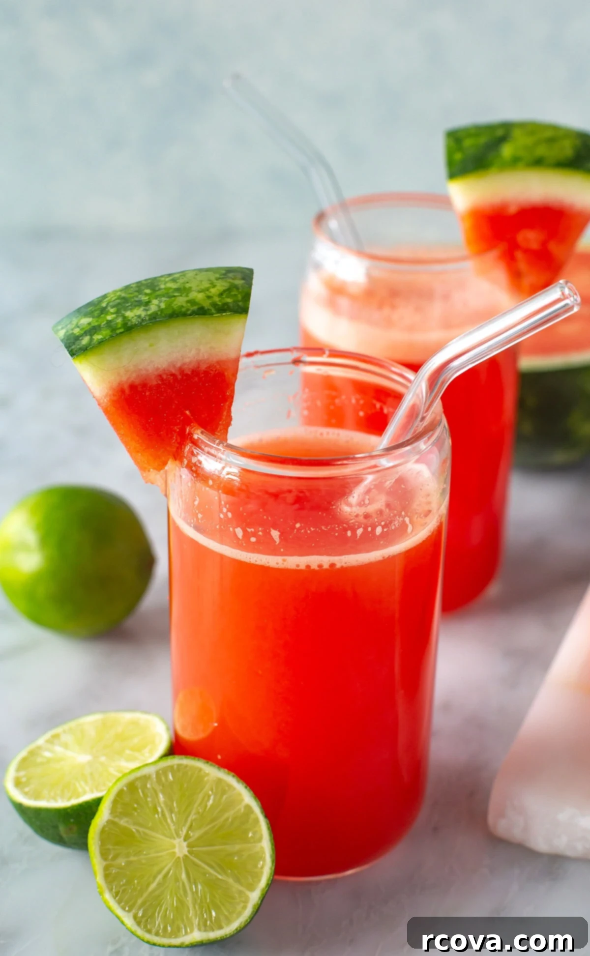 Ruby Red Watermelon Refresher 2 Side shot of a glass of watermelon juice with lime and watermelon slice, invitingly cool.