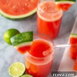Ruby Red Watermelon Refresher 8 Overhead shot of two glasses of watermelon juice with garnishes and fruit.