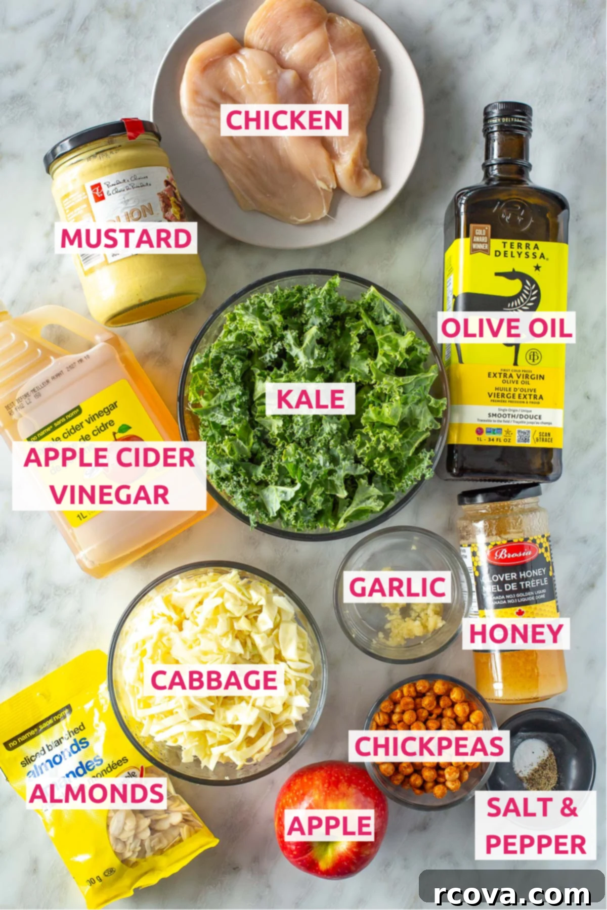 Ultimate Kale Crunch Salad 4 Overhead shot of all the ingredients for kale crunch salad with labels, including chicken, kale, cabbage, apples, almonds, and dressing components.