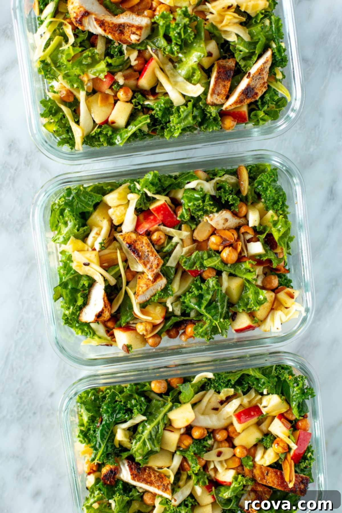 Ultimate Kale Crunch Salad 10 Overhead shot of three meal prep containers filled with kale crunch salad, ready for the week.