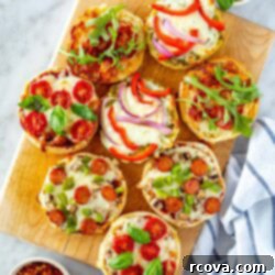 Whip Up Simple Mini Pizzas at Home 10 Several different English muffin pizzas on a butcher block.