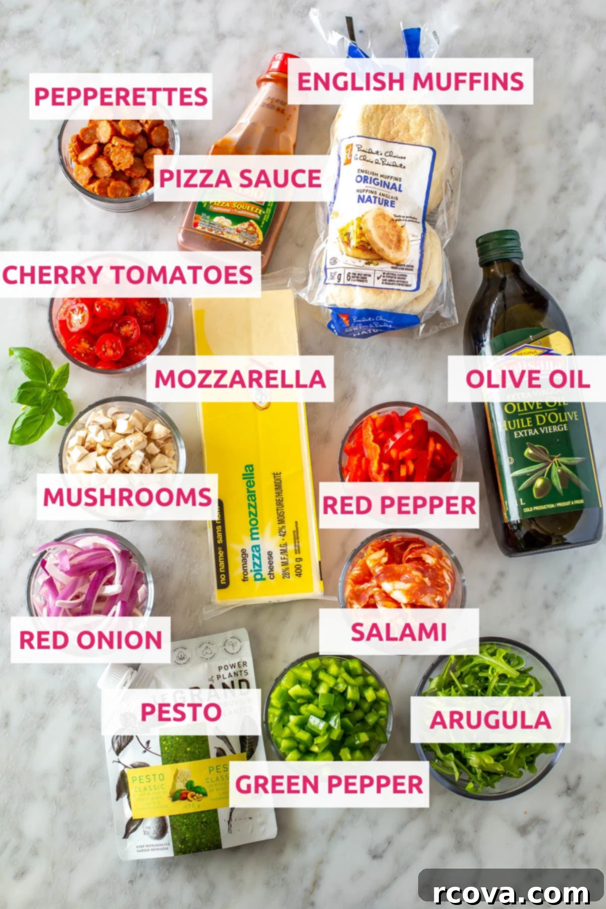 Whip Up Simple Mini Pizzas at Home 4 Ingredients for english muffin pizzas: english muffins, pizza sauce, mozzarella cheese, pepperettes, olive oil, cherry tomatoes, mushrooms, red pepper, red onion, salami, pesto, green pepper and arugula.