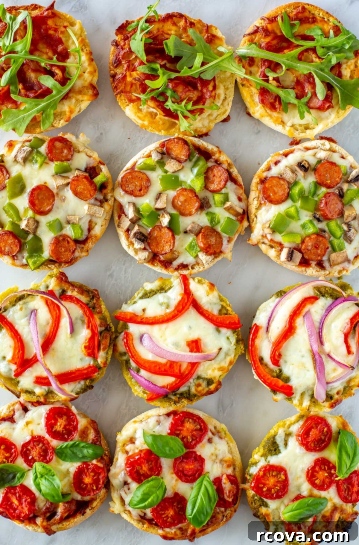 Whip Up Simple Mini Pizzas at Home 9 A close-up of 12 english muffin pizzas on a marble slab.