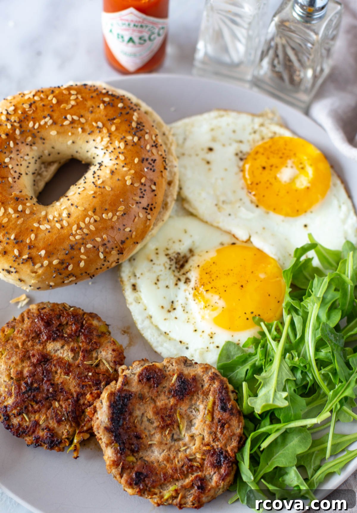 Sweet & Savory Chicken Apple Sausage 8 Overhead shot of two cooked chicken apple sausage patties, eggs, and a bagel.