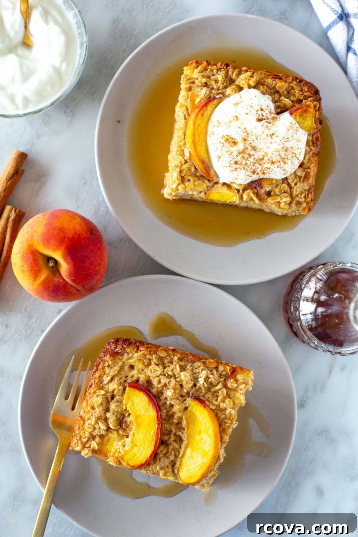 Protein-Packed Peachy Baked Oats 8 Overhead shot of two servings of baked peach oatmeal on plates with syrup, ready to be enjoyed.