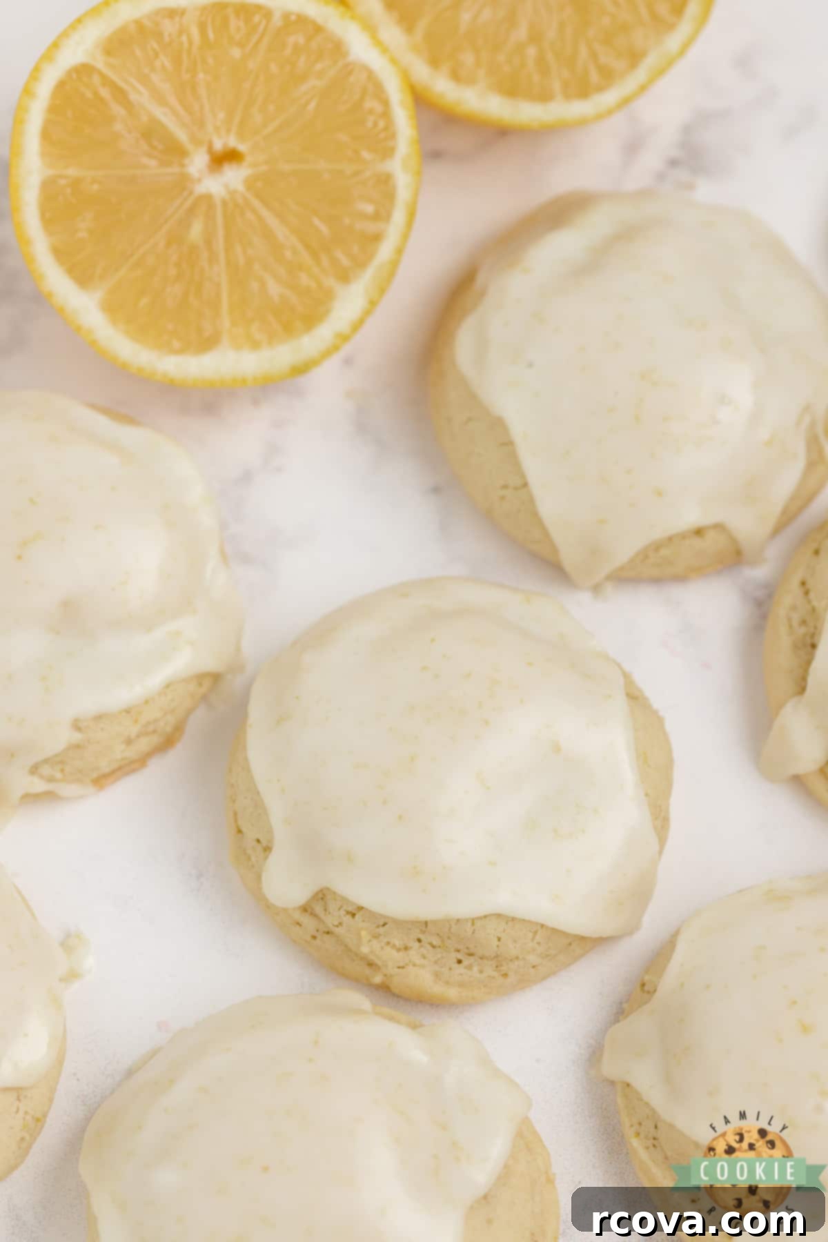 Sunshine Lemon Cheesecake Cookies 2 Soft, thick lemon cream cheese cookies with a bright lemon glaze, piled high on a white plate