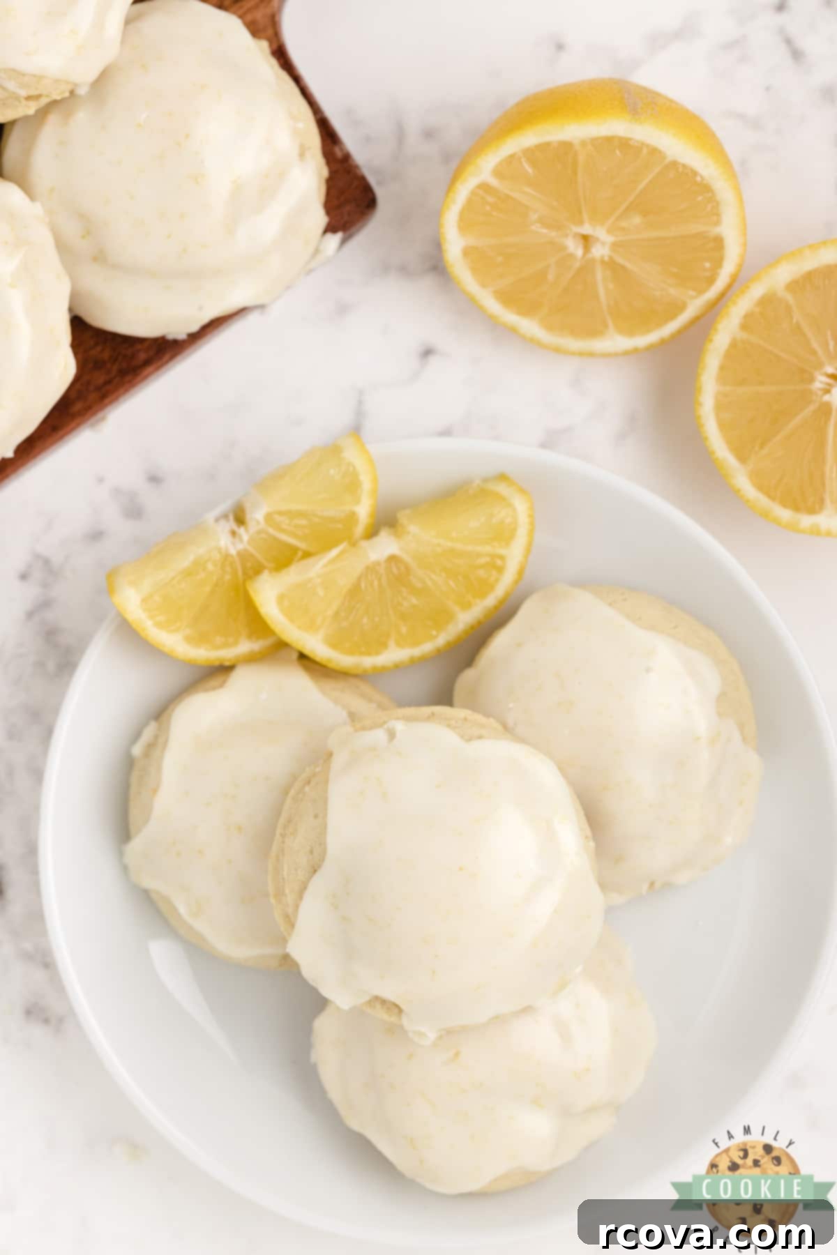 Sunshine Lemon Cheesecake Cookies 9 A plate of thick and soft lemon cookies with a sweet lemon icing, ready to be enjoyed