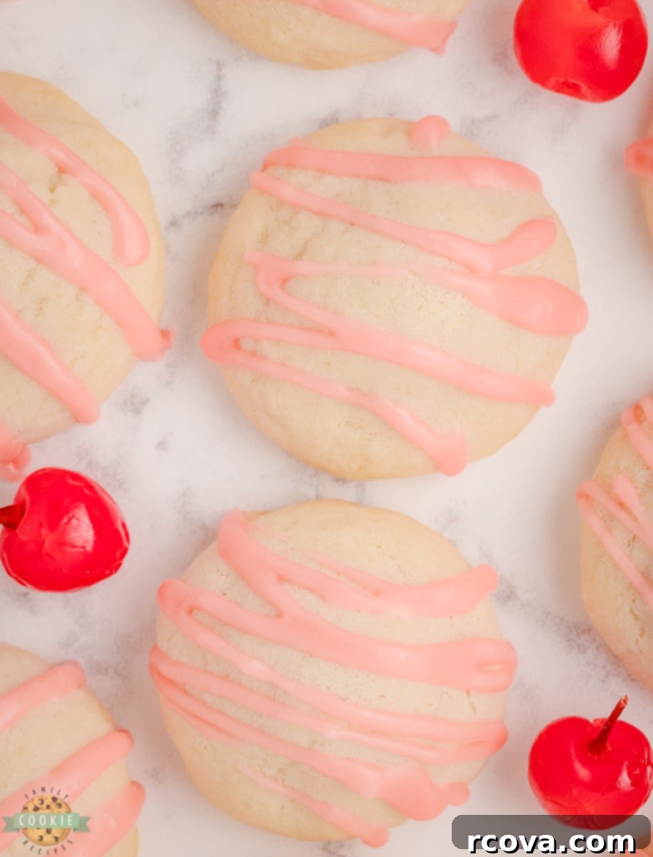 Crimson Cherry Shortbread Gems 5 Unbaked shortbread cookie dough balls with visible maraschino cherry centers on a baking sheet.