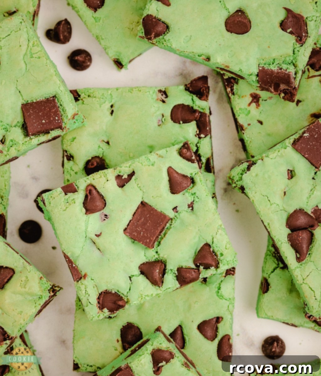 Refreshing Mint Chocolate Chip Cookie Bars 3 Close-up of vibrant green mint chocolate chip cookie bars, freshly baked and ready to be cut.