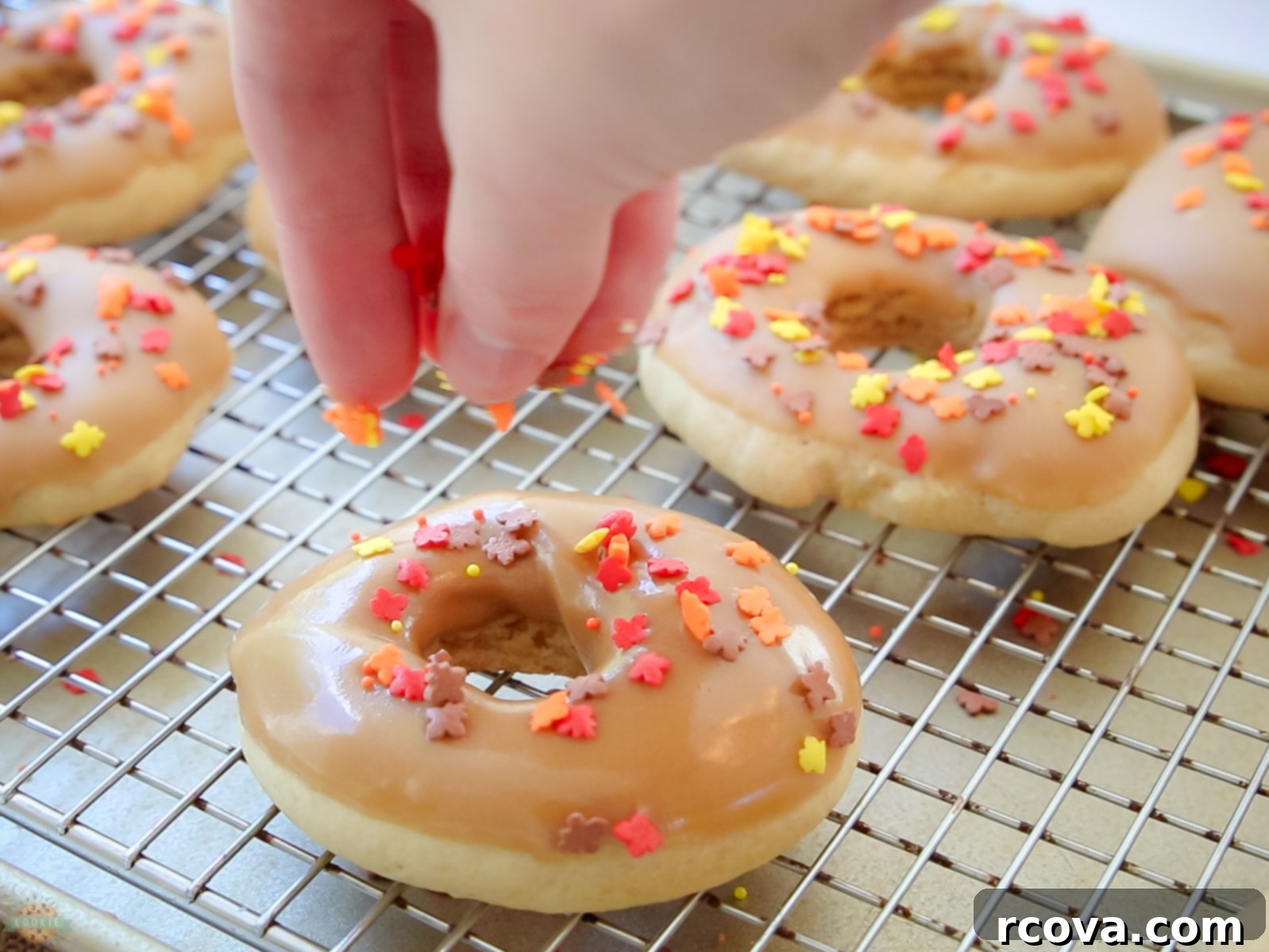 Maple Donut Delights 4 adding sprinkles to the top of maple donut cookies
