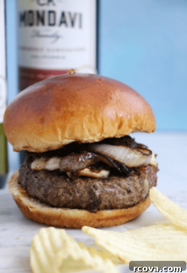 Bacon Brie Burger with Merlot-Caramelized Onions 2 Gourmet Bacon Brie Burger with Merlot Onions served on a wooden board