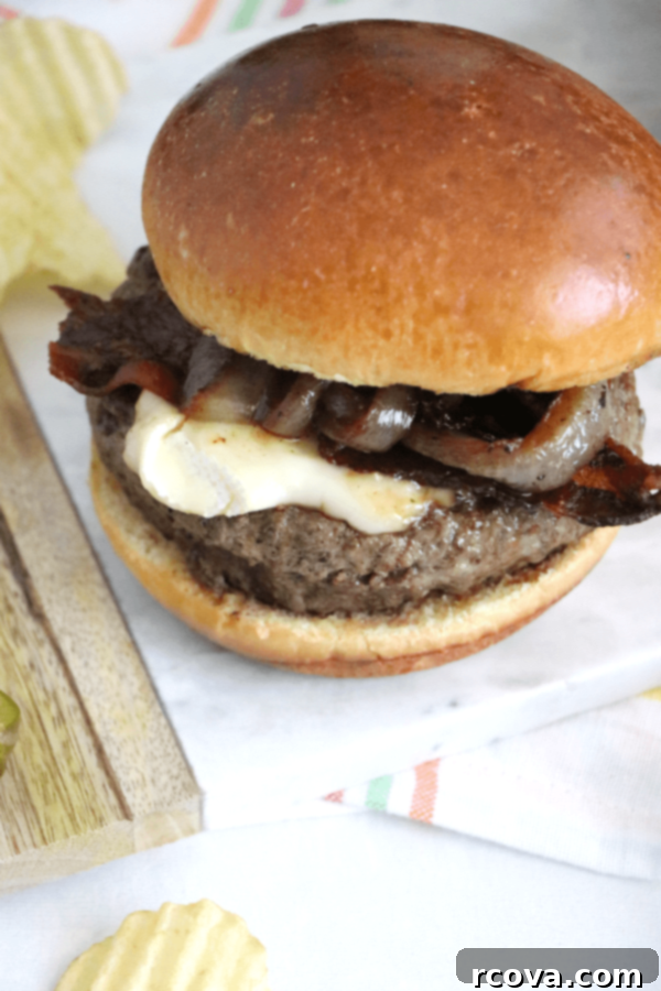 Bacon Brie Burger with Merlot-Caramelized Onions 3 Close up of Bacon Brie Burger with juicy patty and melted cheese