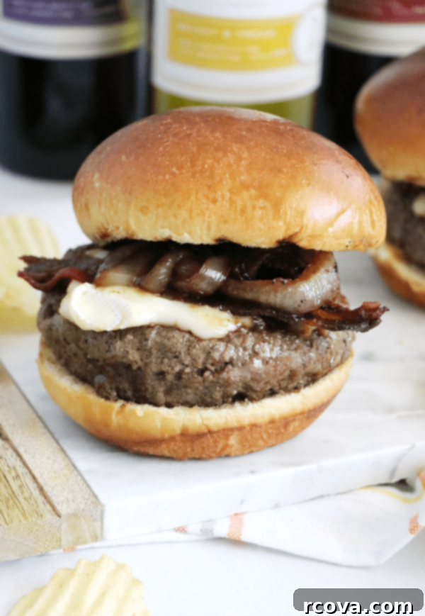 Bacon Brie Burger with Merlot-Caramelized Onions 4 Bacon Brie Burger with Merlot Onions on a plate with fresh greens