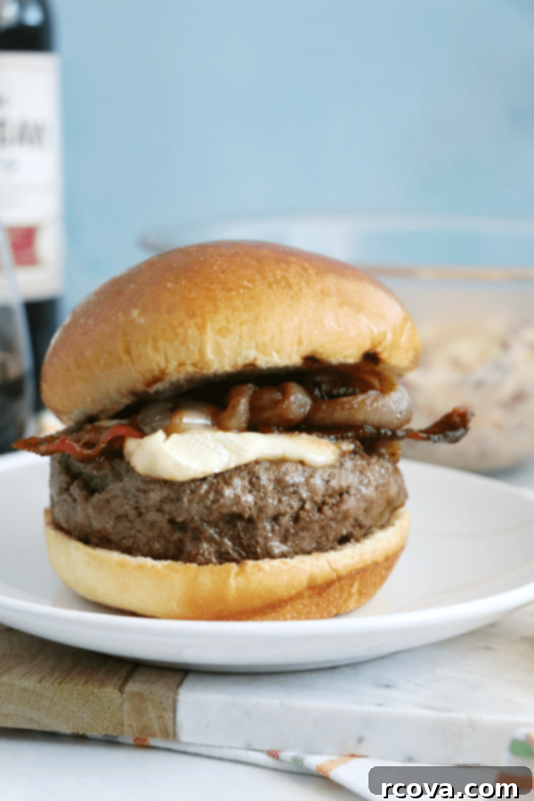 Bacon Brie Burger with Merlot-Caramelized Onions 6 Top view of Bacon Brie Burger with melted brie and crispy bacon