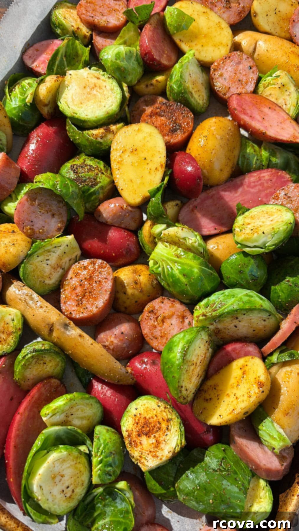 Sheet Pan Chicken Sausage and Veggies 2 A sheet pan filled with roasted chicken sausage, baby red potatoes, and Brussels sprouts, ready to be served.