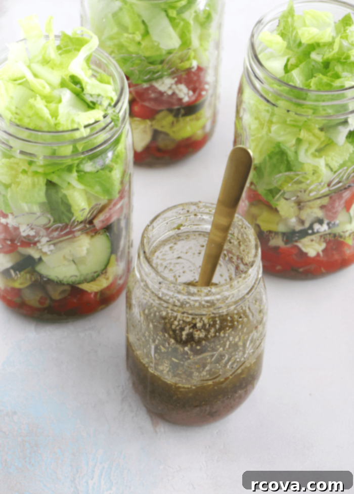 Mason Jar Antipasto: Italian Flavor On-the-Go 4 A top-down view of multiple mason jars filled with chopped antipasto salad, ready for meal prep.