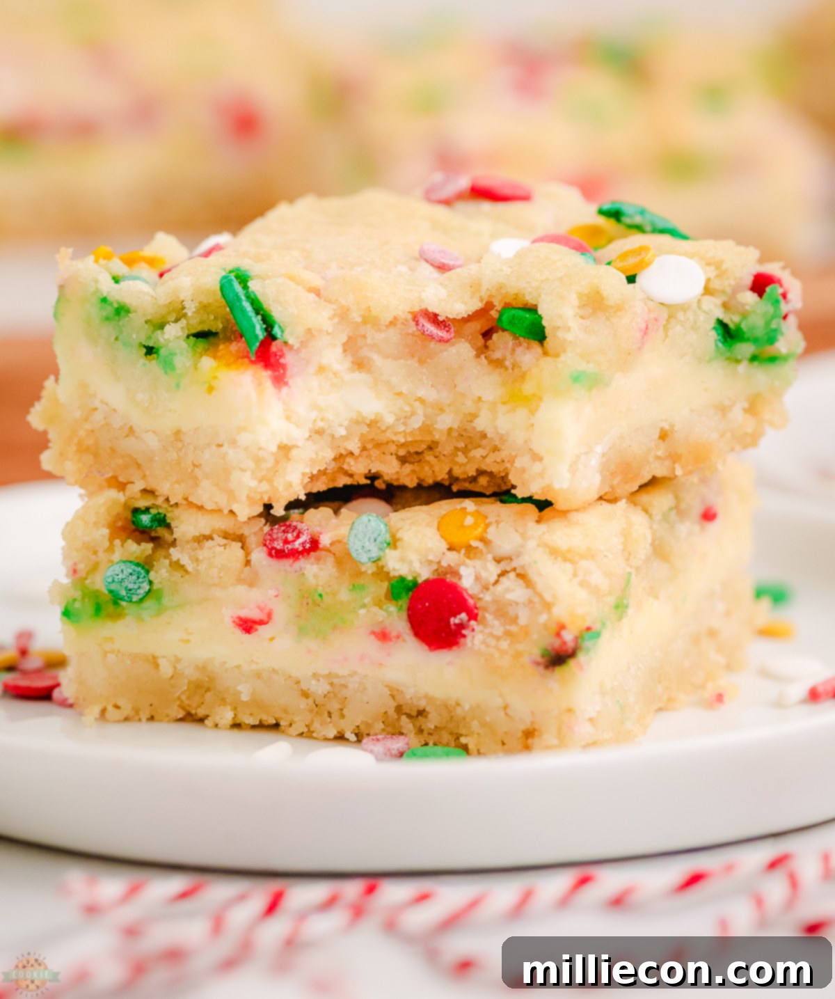Christmas Cheesecake Sugar Cookie Bars on a white plate